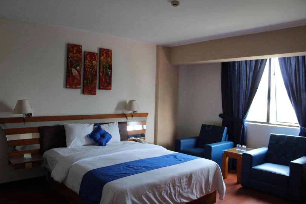 Postel nebo postele na pokoji v ubytování Blue Star Hotel