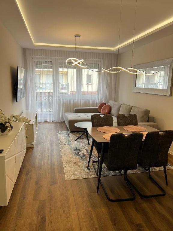 a living room with a table and a couch at Vivien Apartman in Nyíregyháza