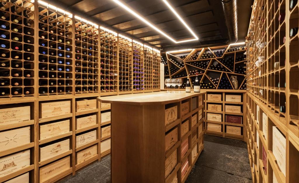 a wine cellar with wooden wine racks and a bar at Boutique Hotel Glacier in Grindelwald