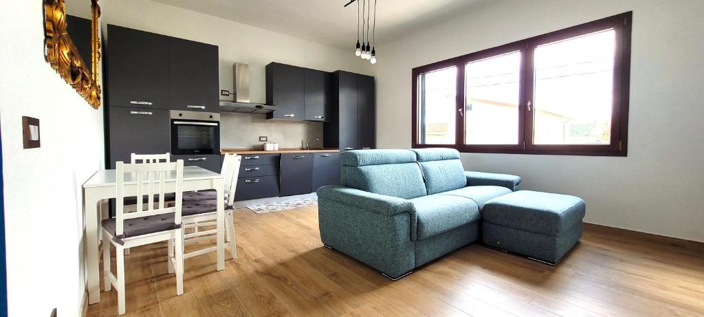 a living room with a couch and a chair and a table at Casa Nue - Appartamento Deluxe in Posada