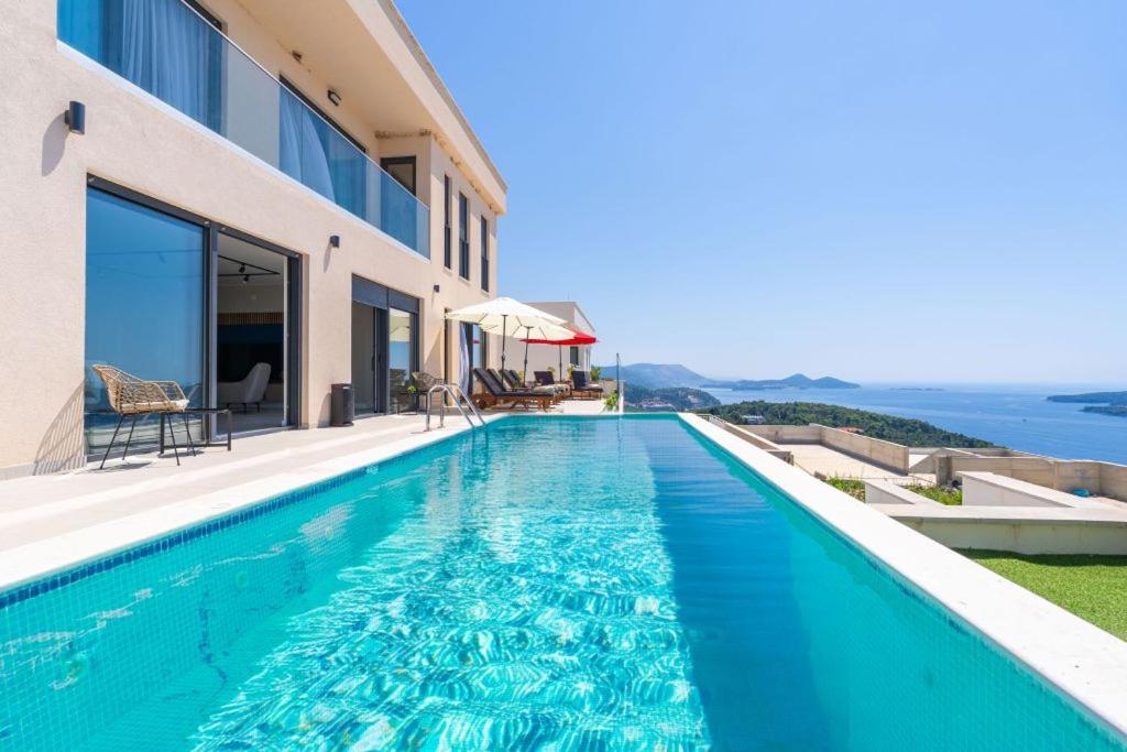 a swimming pool in a house with a view of the ocean at Green Horizon Sea Views Villa in Dubrovnik