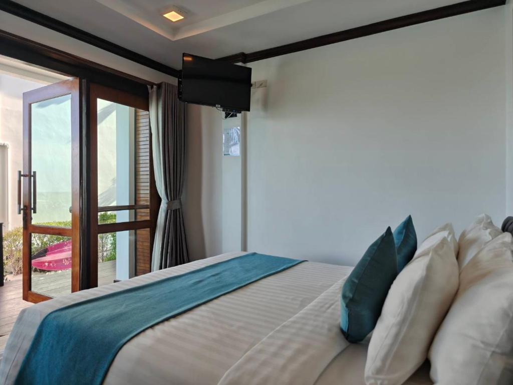 a bedroom with a large bed and a balcony at Cabana Lipe Beach Resort in Ko Lipe