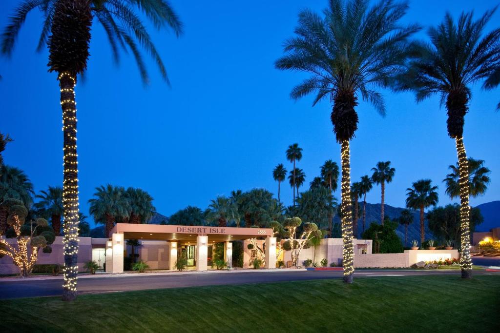 a hotel with palm trees in front of it at Desert Isle Resort, a VRI resort in Palm Springs