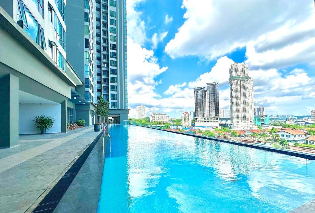 a swimming pool in the middle of a city with buildings at SKS Pavillion Residences Johor Bahru in Johor Bahru