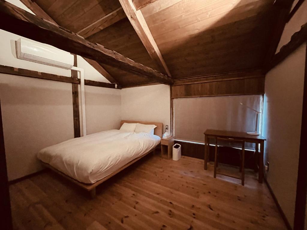 Postel nebo postele na pokoji v ubytování MITSU-House