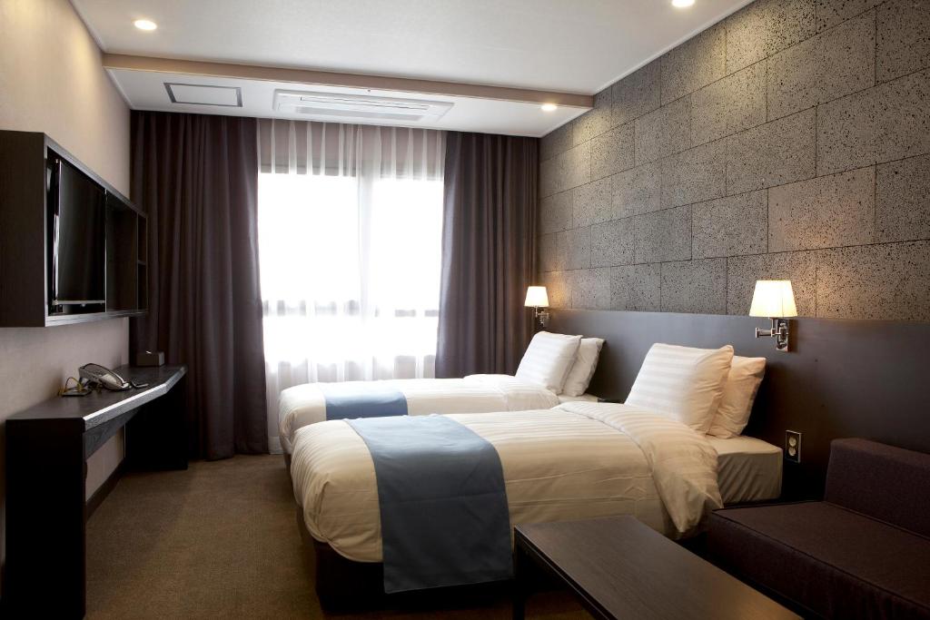 Postel nebo postele na pokoji v ubytování S Stay Dongtan Hotel