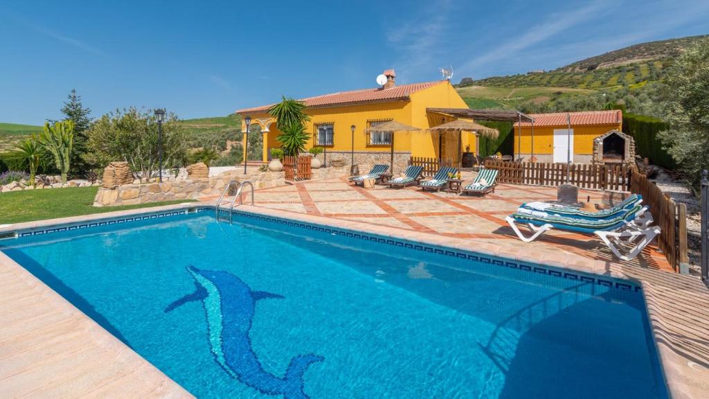 a swimming pool in front of a house at Villa Jose y Ana Antequera - La Joya by Ruralidays in Antequera