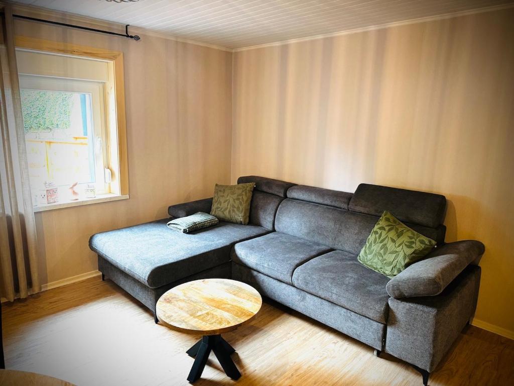 a living room with a couch and a table at La Tanière du Katz in Dabo