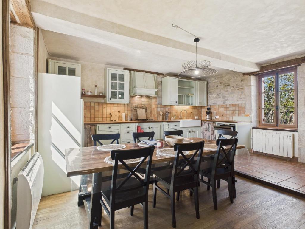 a kitchen and dining room with a table and chairs at À la campagne, belle maison pour 8 avec piscine in Gabillou