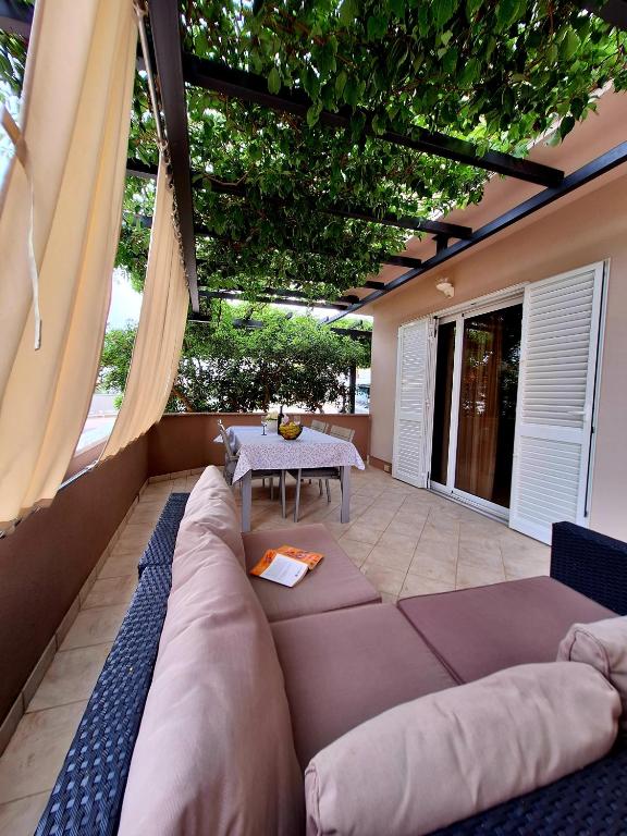 a living room with a couch and a table at The Golden Island apartments in Krk
