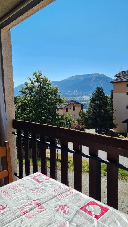 d'un balcon avec une table et une vue sur la montagne. dans l'établissement Studio cabine - centre Font-Romeu, à Font-Romeu