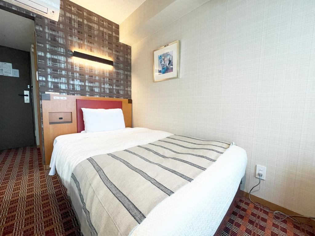 Postel nebo postele na pokoji v ubytování Garden Hotel Shizuoka