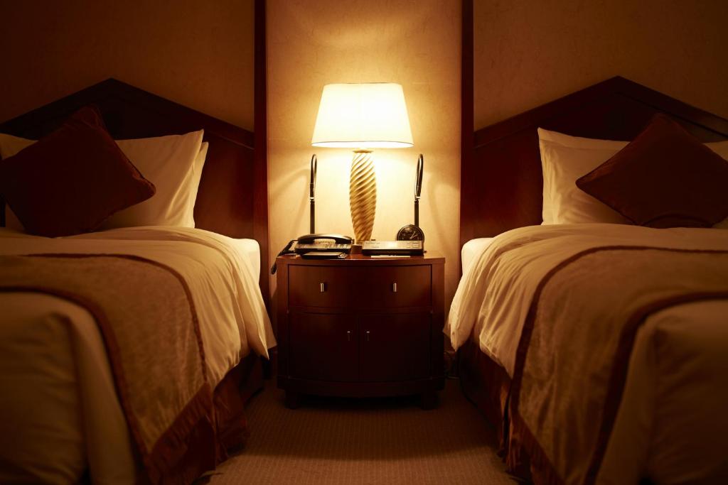 Postel nebo postele na pokoji v ubytování Imperial Hotel Osaka