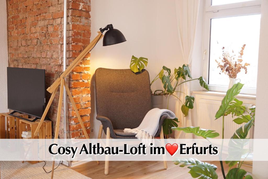 a living room with a chair and a lamp at Helles Altbau-Loft mit Kingsize Bett, Smart-TV, etc in Erfurt