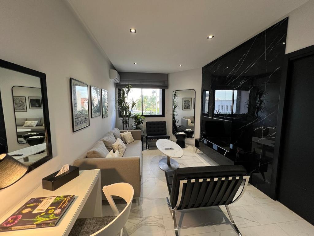 a living room with a couch and a television at Only You in Sidi Daoud