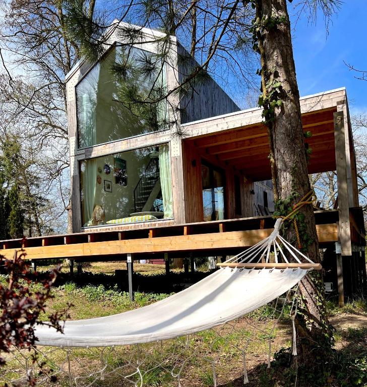 a hammock in front of a house at Bosco Uno in Łagów