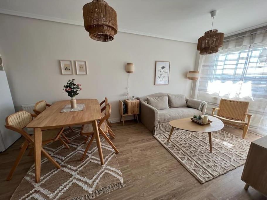 a living room with a couch and a table at Alquiler apartamento playa in Suances
