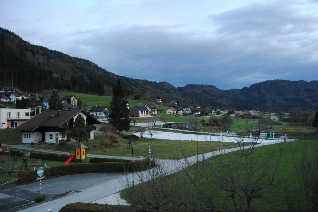 a small town with a road and houses and mountains at Fewo Ossiach in Ossiach
