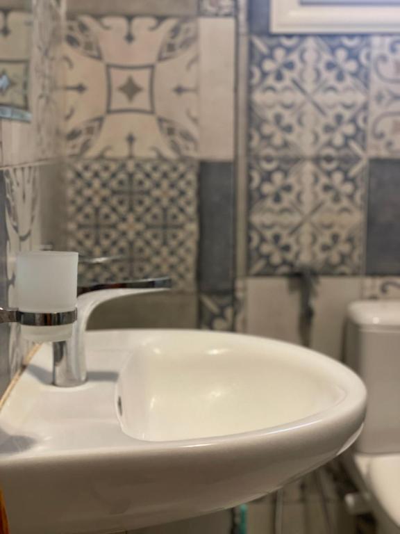 a bathroom with a white sink and a toilet at Baraa house in Cairo