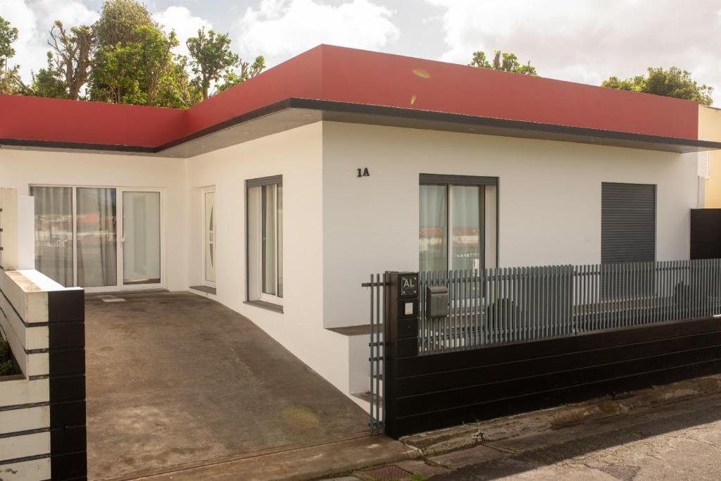 a house with a red roof at Casa do Cédro in Vila Franca do Campo