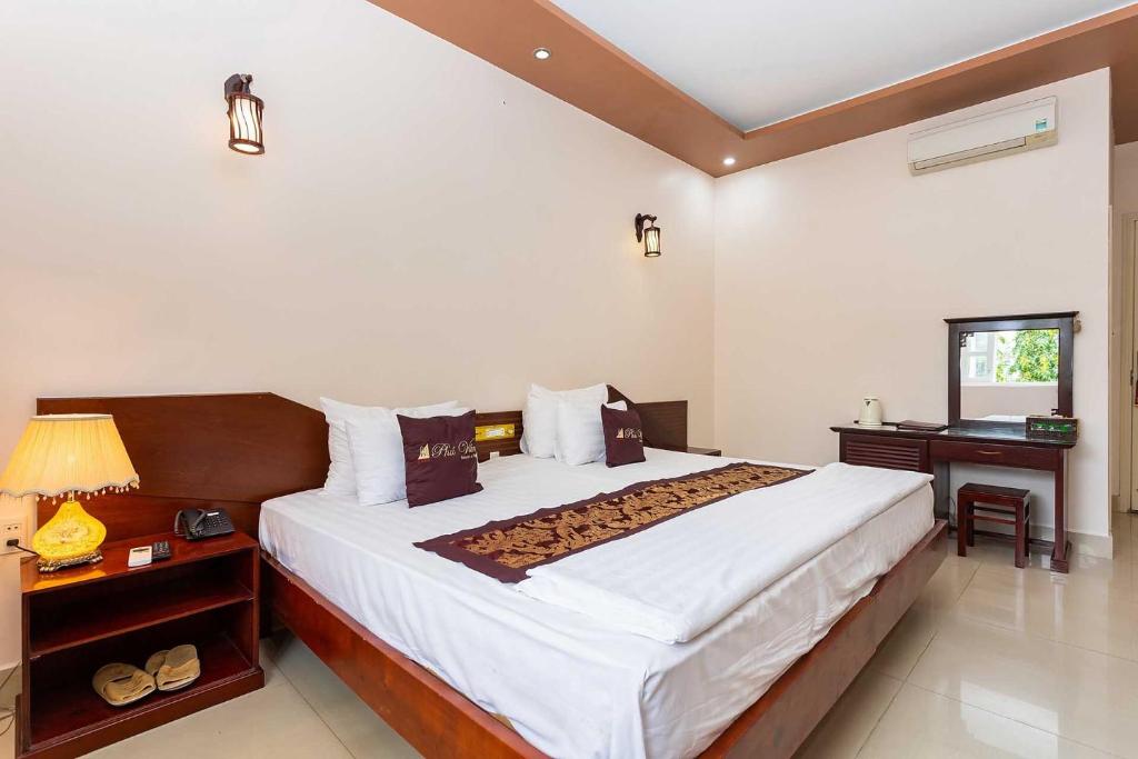 Postel nebo postele na pokoji v ubytování Phu Van Resort & Spa Phu Quoc