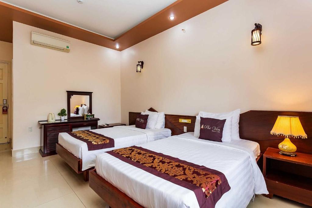 Postel nebo postele na pokoji v ubytování Phu Van Resort & Spa Phu Quoc