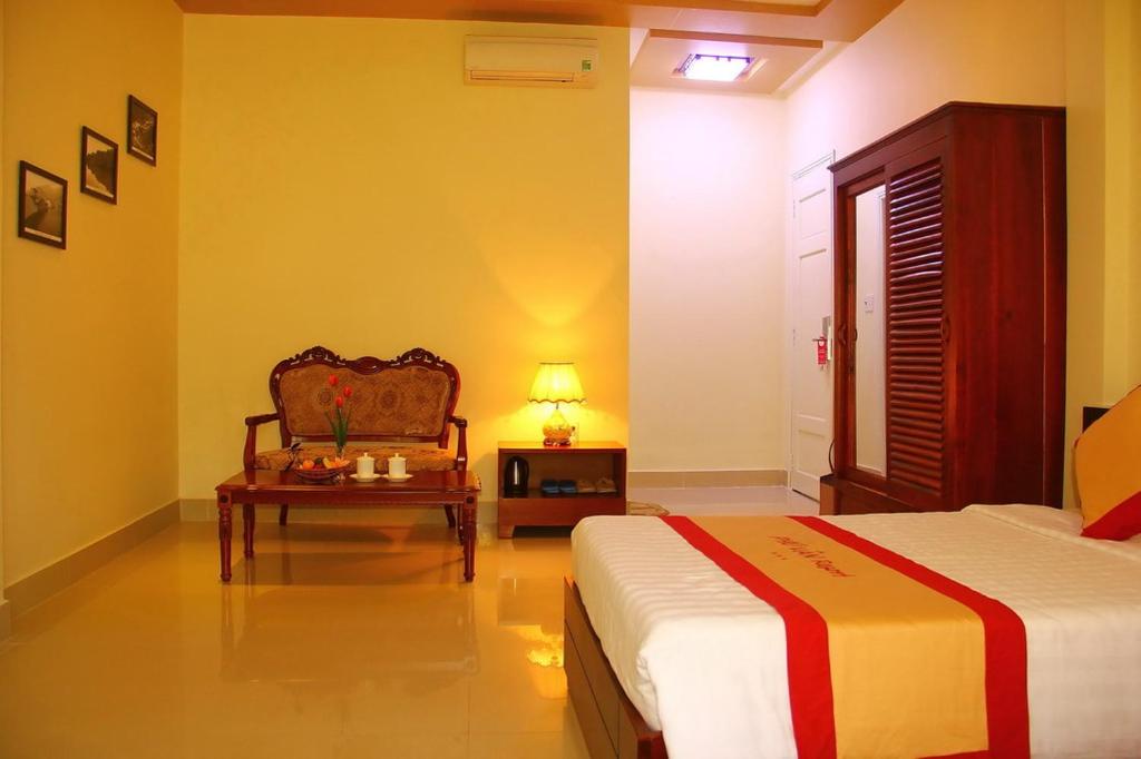 Postel nebo postele na pokoji v ubytování Phu Van Resort & Spa Phu Quoc