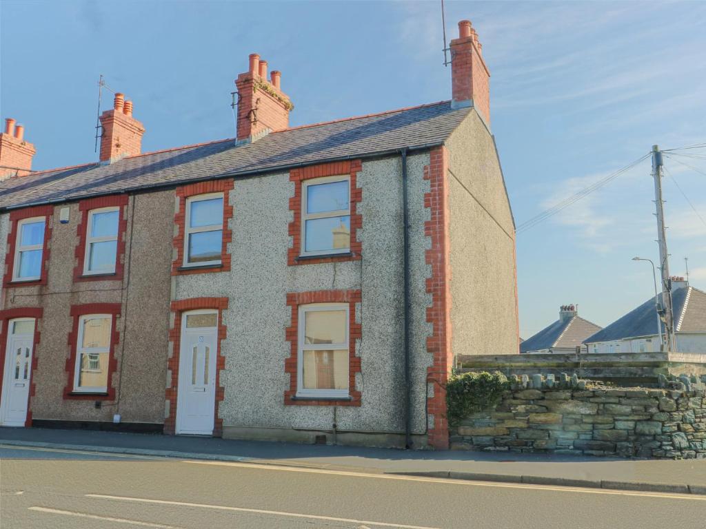 a brick building on the side of a street at 63 Kingsland Road in Holyhead