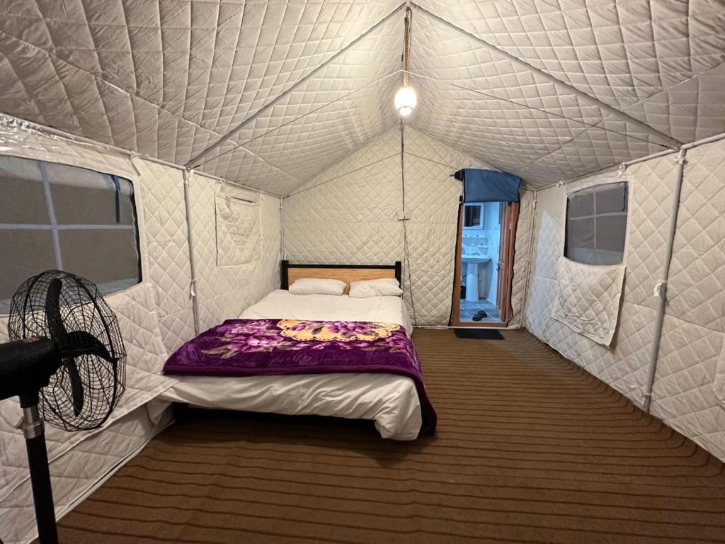 a bedroom in a tent with a bed in it at Valhalla Guest House Skardu in Skardu
