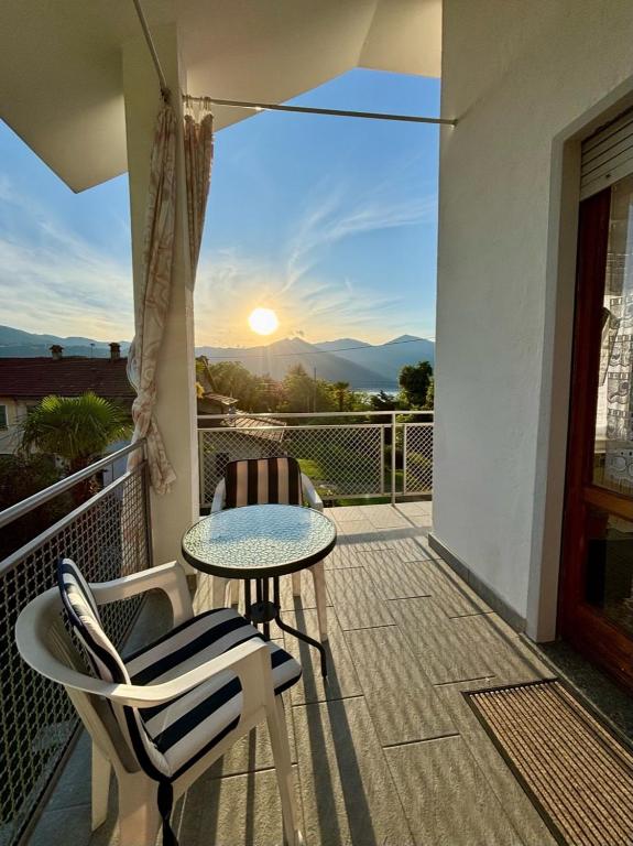 eine Terrasse mit Tisch und Stühlen auf einem Balkon in der Unterkunft Guest House le Palme in Orta San Giulio