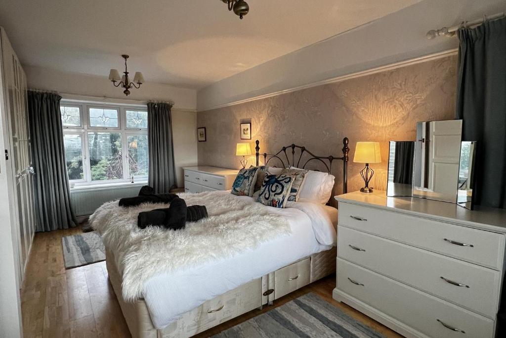 a bedroom with a large white bed and a window at Mumbles Seaside sleeps up 11 Pets allowed in Swansea