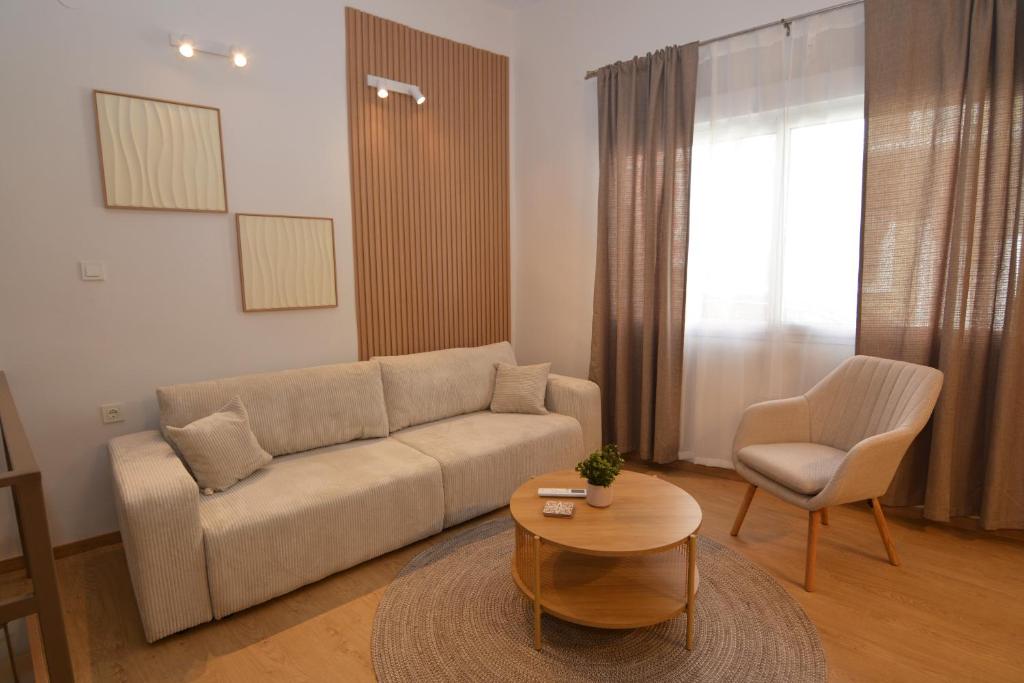 a living room with a couch and a table and a chair at Liora Retreat in Kavála