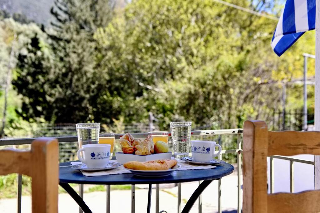 a blue table with a plate of food on it at Prokopis House in Sívros