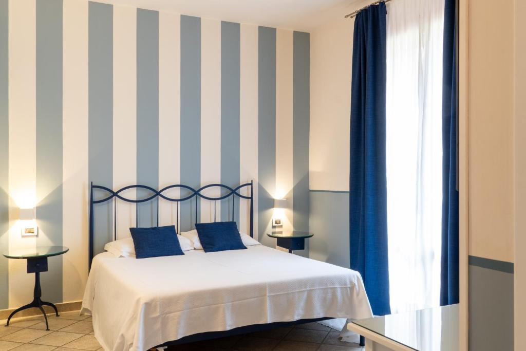 Postel nebo postele na pokoji v ubytování Hotel Le Colline