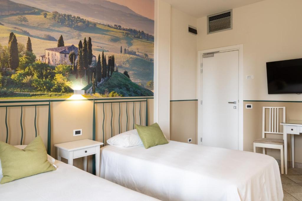 Postel nebo postele na pokoji v ubytování Hotel Le Colline
