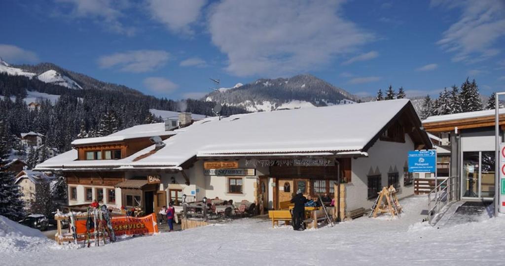 a ski lodge with snow on top of it at Appartamenti La Munt in Badia