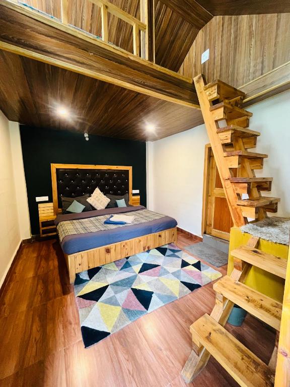 a bedroom with a bunk bed and a wooden staircase at The Dreamcatcher room’s & cafe in Kasol