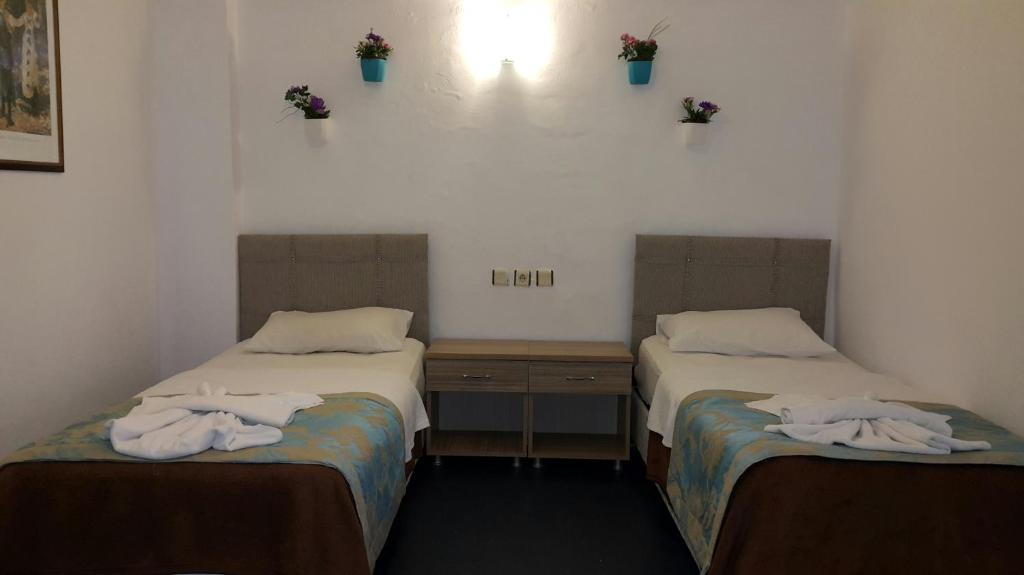 A bed or beds in a room at Angels Inn Marmaris