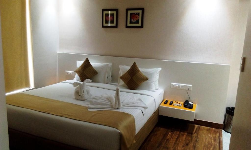 Postel nebo postele na pokoji v ubytování Mango Hotels Prangan