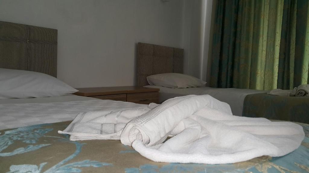 A bed or beds in a room at Angels Inn Marmaris