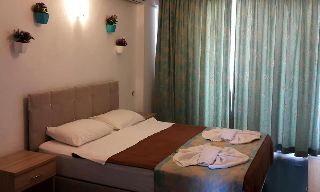 A bed or beds in a room at Angels Inn Marmaris