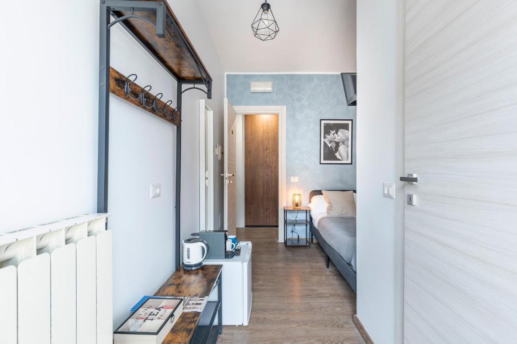 a hallway with a bedroom with a bed and a mirror at Bnb Drive In in Rome