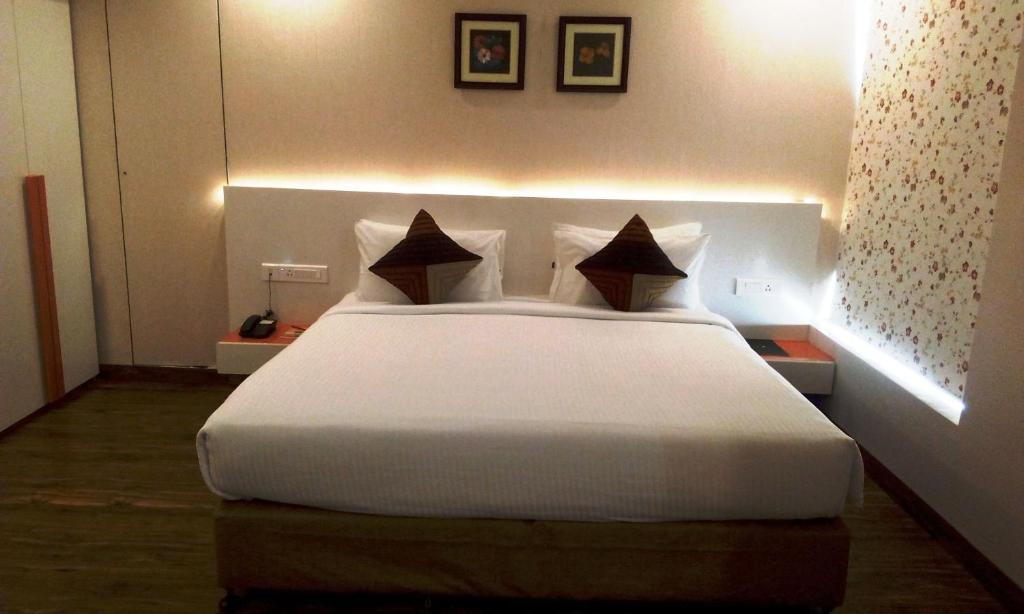 Postel nebo postele na pokoji v ubytování Mango Hotels Prangan