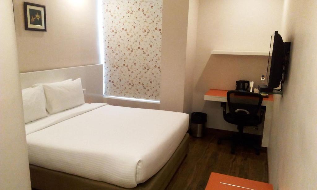 Postel nebo postele na pokoji v ubytování Mango Hotels Prangan