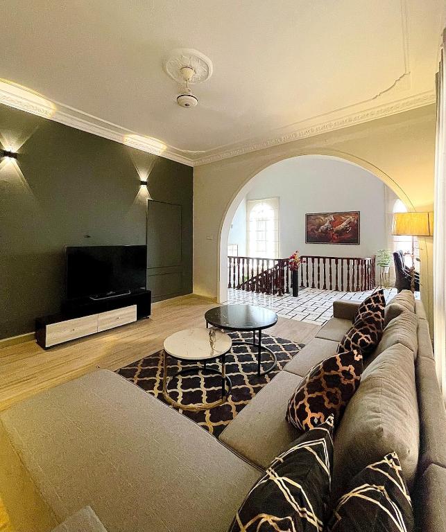 a living room with a couch and a tv at 3 BDR F10-1 Escape in Islamabad