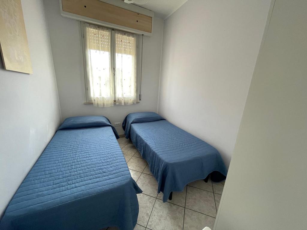 Postel nebo postele na pokoji v ubytování Residenza Lido adriano baia tartaruga