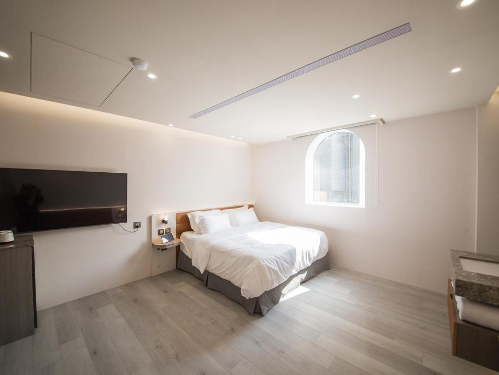 Postel nebo postele na pokoji v ubytování LIVIN Hotel