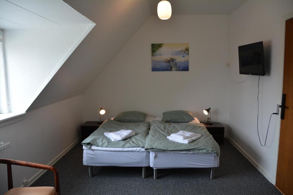 Postel nebo postele na pokoji v ubytování Abild Hotel
