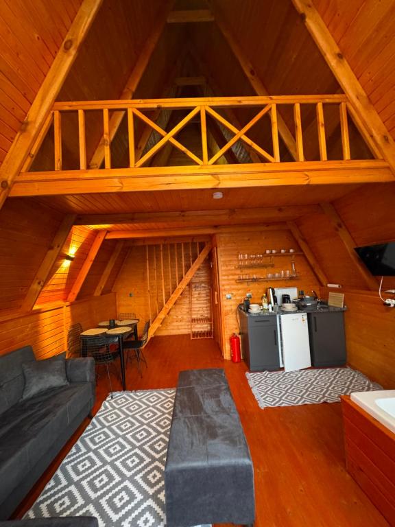 an attic room with a couch and a stove at Amasra Blue Horizon Bungalow in Eskiömerler