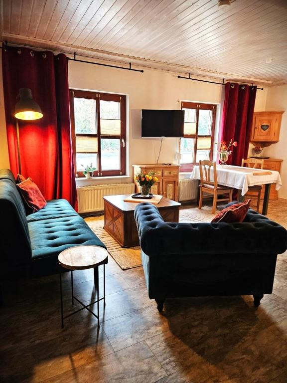 a living room with a couch and a table at FeWo Alpenstube in Neue Scheune